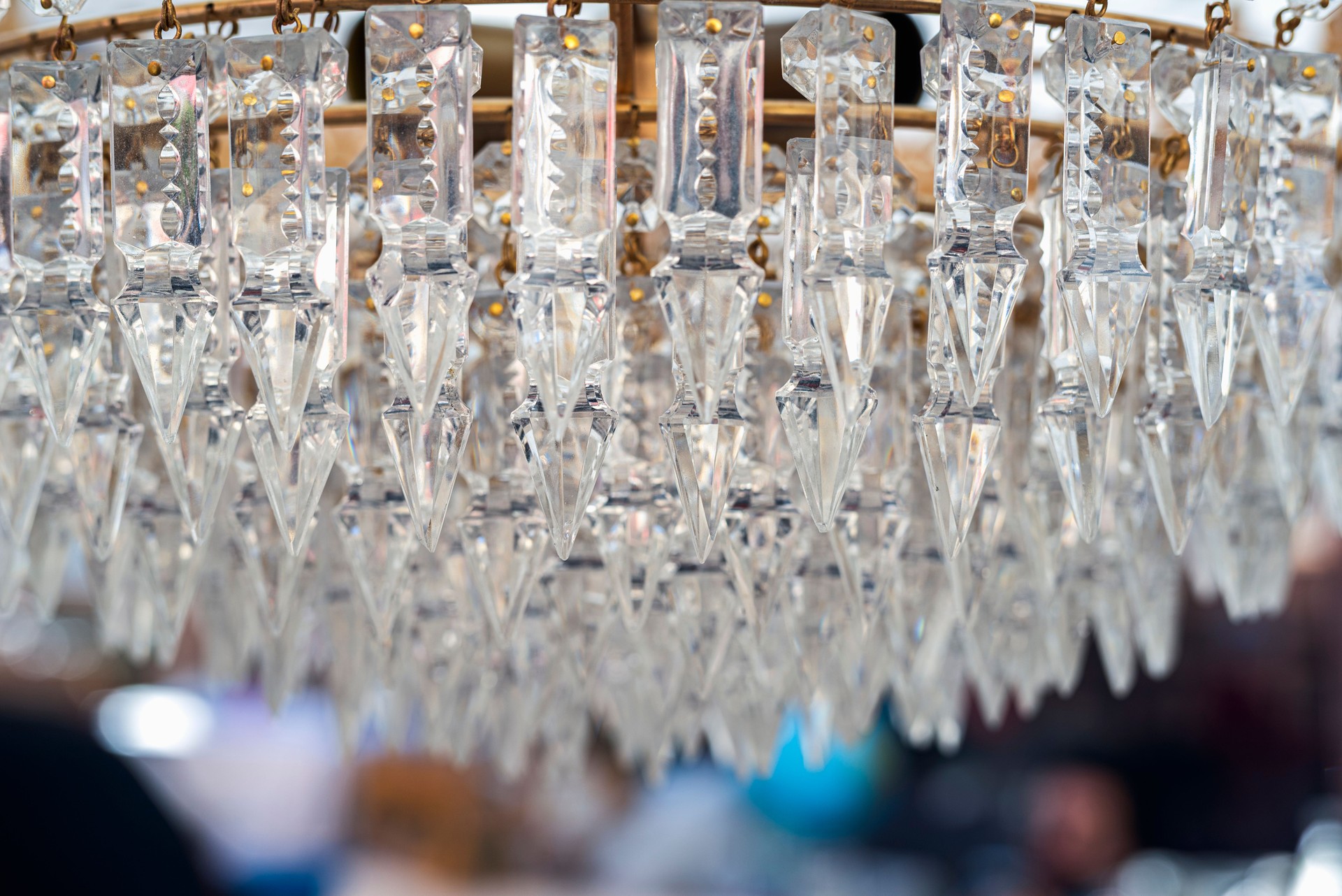 Crystal chandelier at a flea market, showcasing intricate glasswork and sparkling light reflections